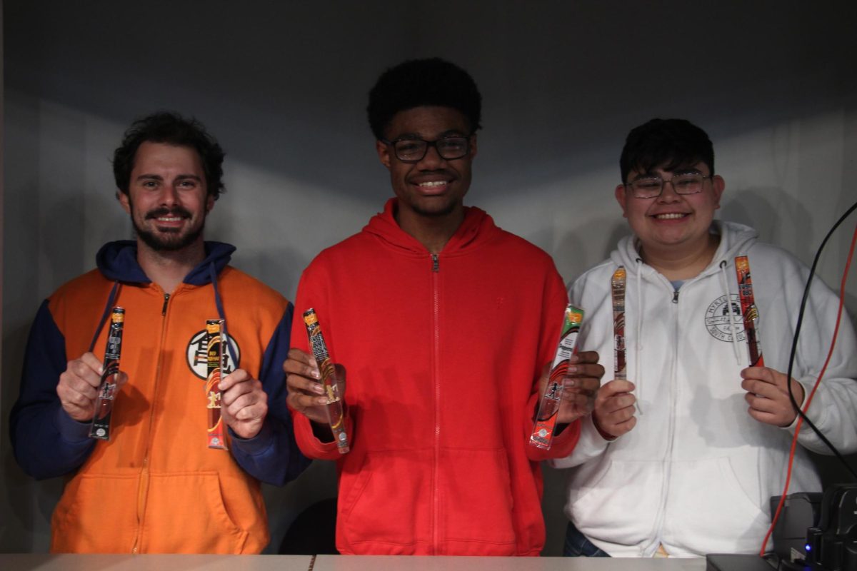 Mr. Carter and seniors JaCori Johns and Ricky Iraheta showcase the variety of meat stick flavors available in their fundraiser. Grab yours for just $2 and support the club’s initiatives!