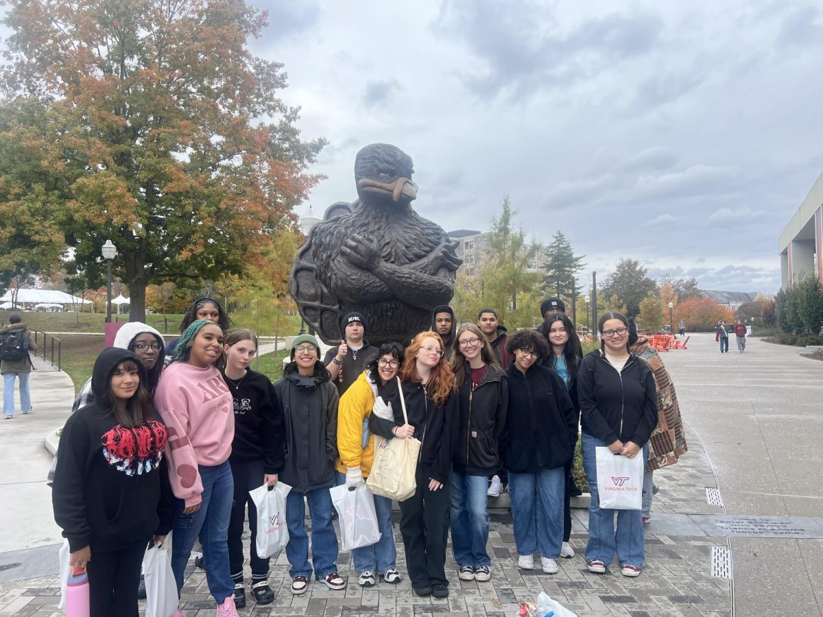 Group of Galileo Students at The Virginia Tech Tour posing in front of the mascot statue.